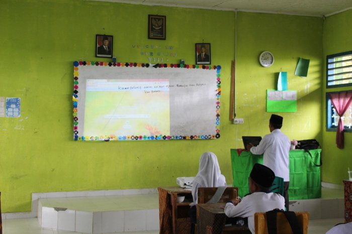 ?? Ciptakan Suasana Belajar Menyenangkan, Pak Herzal Imani Gunakan Proyektor dalam Pembelajaran TIK Kelas 8C